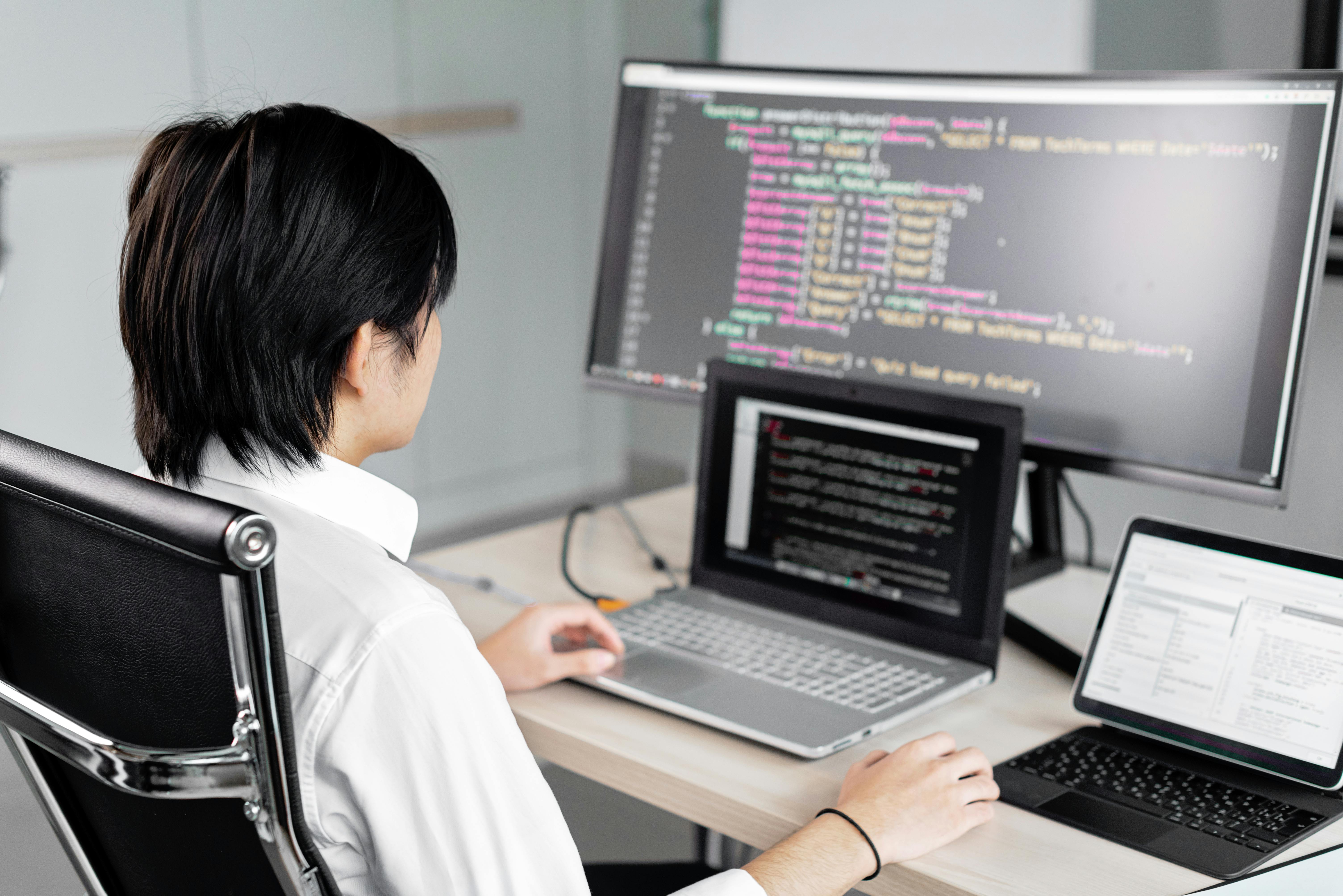 Ingeniero de software trabajando en múltiples pantallas